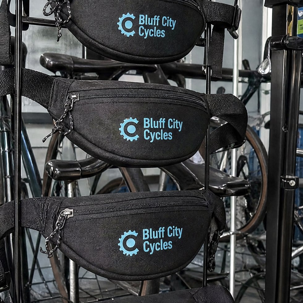 Custom hip packs with logo hanging on a display rack